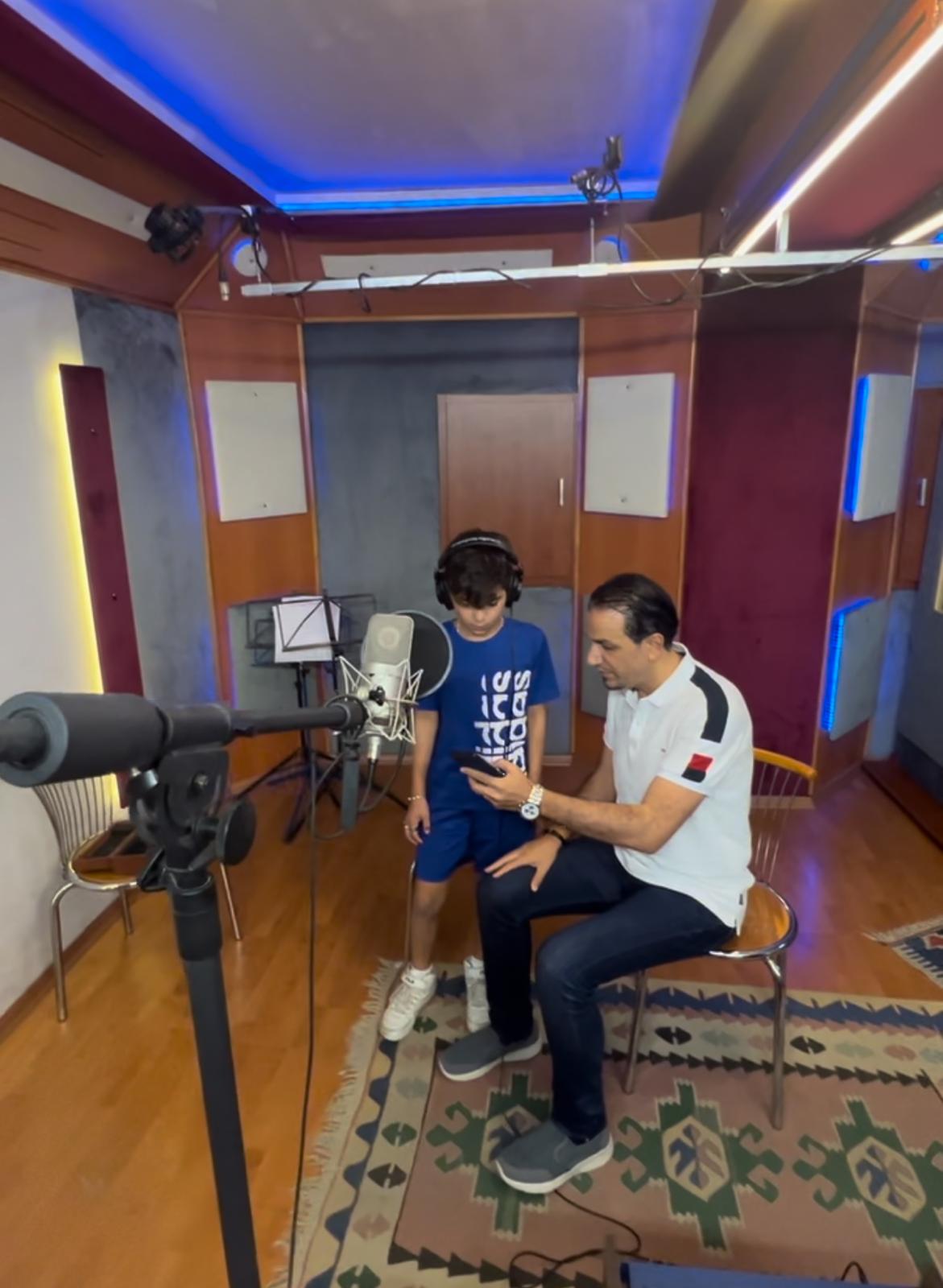 Arabic-Music-Producer-Collaborating-With-Artist Arabic music producer providing creative direction and reviewing lyrics with young artist Rayan Ghabayen.